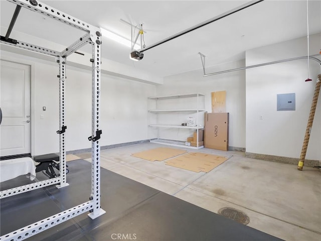 garage featuring baseboards, electric panel, and a garage door opener