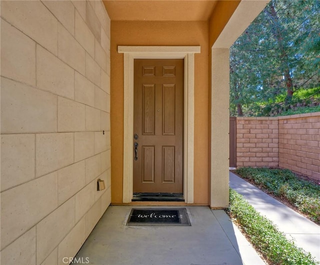 doorway to property with stucco siding