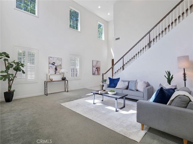 carpeted living room with recessed lighting, baseboards, stairs, and visible vents