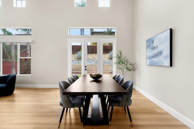 1452 Canoe Creek Way, Chula Vista, CA 91915 - dining space with a towering ceiling, light wood-style floors, and baseboards