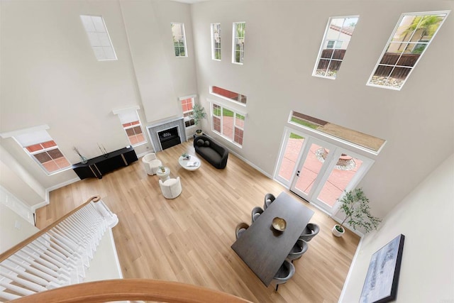 1452 Canoe Creek Way, Chula Vista, CA 91915 - living area with a fireplace, wood finished floors, a towering ceiling, and plenty of natural light