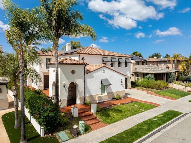 1452 Canoe Creek Way, Chula Vista, CA 91915 - mediterranean / spanish-style house with a residential view, a tile roof, a chimney, concrete driveway, and stucco siding