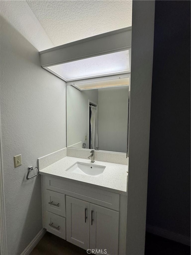 bathroom featuring vanity and baseboards