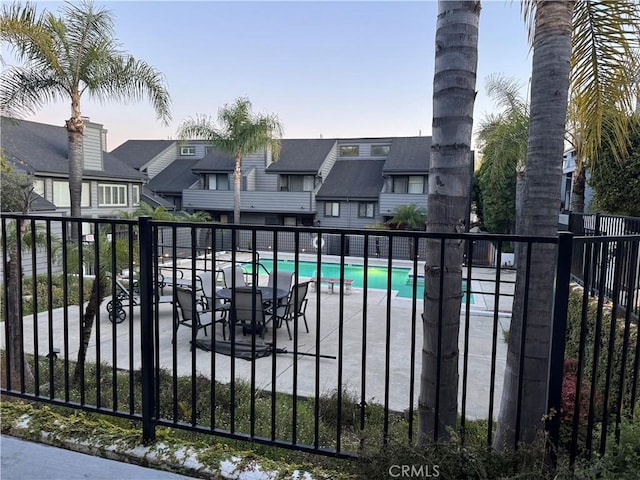 pool with fence and a residential view