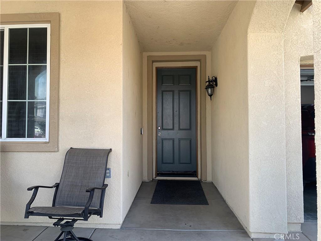 1561 Palma Bonita, Perris, CA 92571 - doorway to property featuring stucco siding