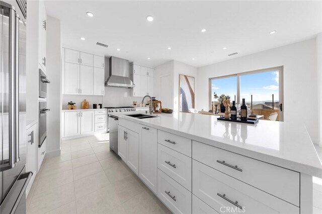 118 Sunnybank Blvd, Irvine, CA 92618 - kitchen featuring white cabinets, wall chimney exhaust hood, a sink, and recessed lighting