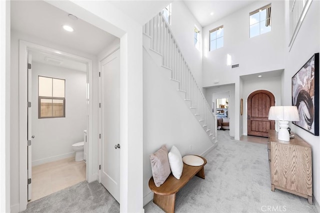 118 Sunnybank Blvd, Irvine, CA 92618 - entrance foyer with light carpet, stairs, visible vents, and baseboards
