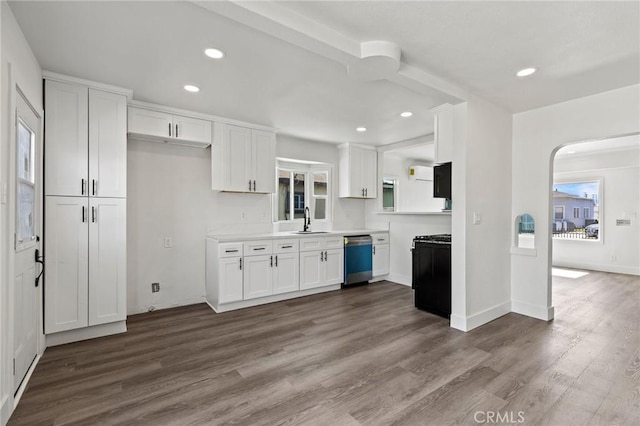 kitchen featuring white cabinetry, a sink, dishwashing machine, and recessed lighting