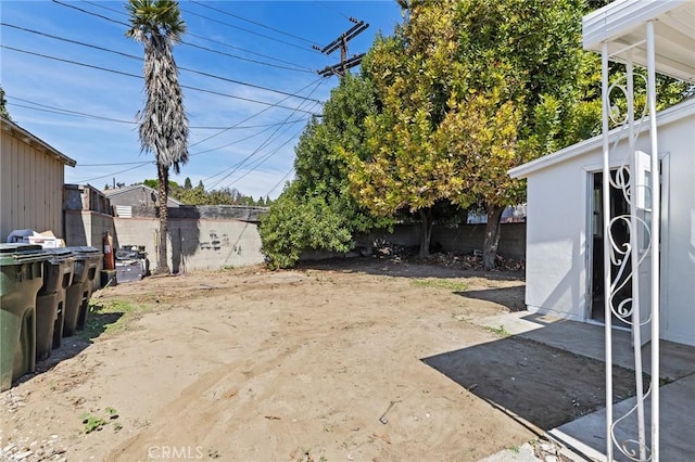 view of yard with a fenced backyard and an outbuilding