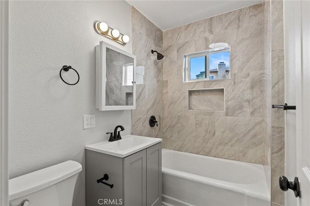 full bath featuring toilet, vanity, and shower / washtub combination