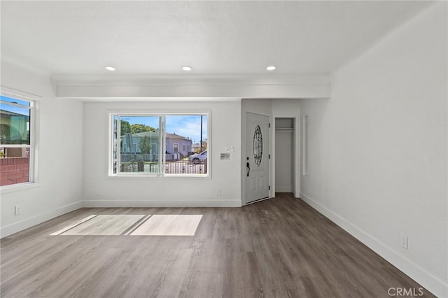 unfurnished room with baseboards, wood finished floors, and recessed lighting