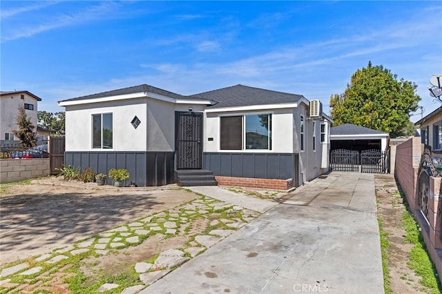 view of front of house with concrete driveway and fence