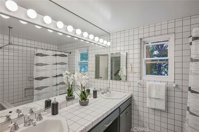 27072 Esward Dr, Calabasas, CA 91301 - full bath with tile walls, double vanity, decorative backsplash, and curtained shower