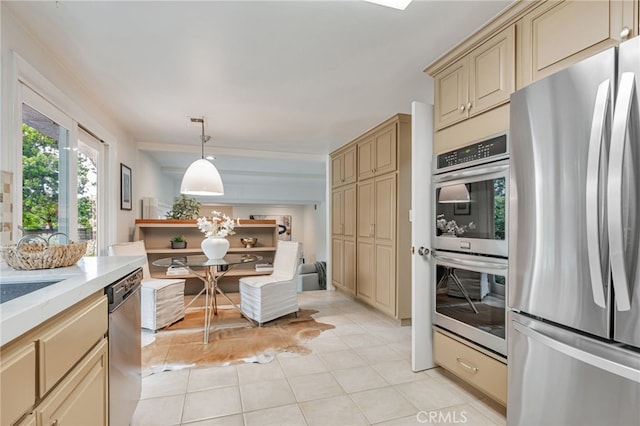 27072 Esward Dr, Calabasas, CA 91301 - kitchen featuring appliances with stainless steel finishes, cream cabinetry, light tile patterned flooring, and pendant lighting