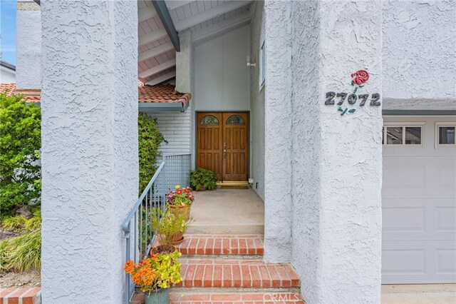 27072 Esward Dr, Calabasas, CA 91301 - entrance to property featuring stucco siding, a garage, and brick siding