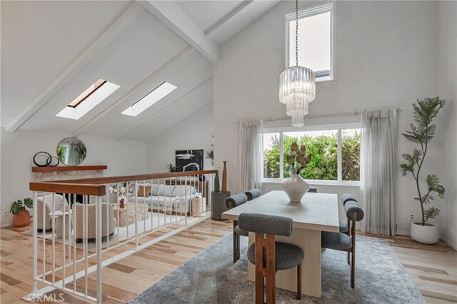 27072 Esward Dr, Calabasas, CA 91301 - dining room featuring a skylight, beam ceiling, wood finished floors, high vaulted ceiling, and a chandelier