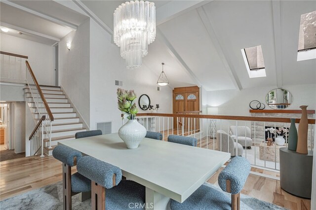 27072 Esward Dr, Calabasas, CA 91301 - dining room with wood finished floors, a skylight, stairway, and a chandelier