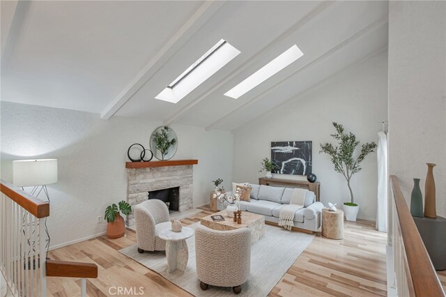 27072 Esward Dr, Calabasas, CA 91301 - living room with a skylight, wood finished floors, and a fireplace