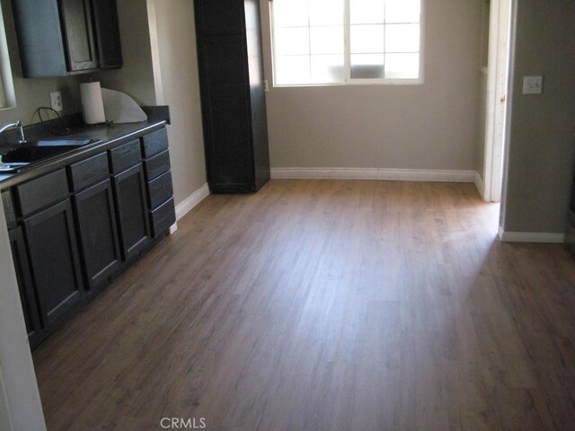 interior space with baseboards and wood finished floors