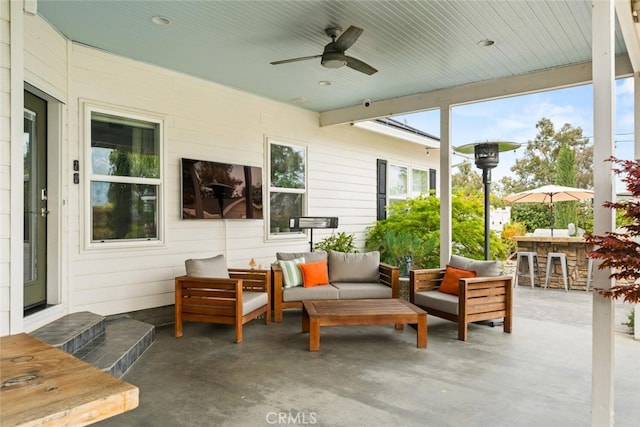 sunroom with a ceiling fan, outdoor dry bar, and an outdoor living space