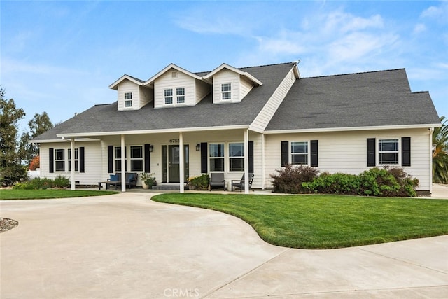 cape cod-style house with a front lawn and covered porch