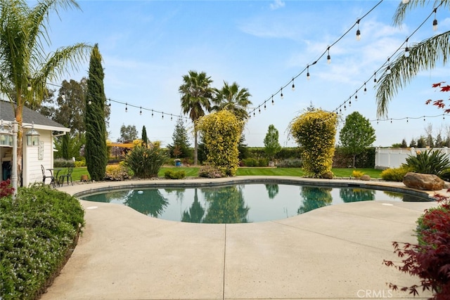 pool featuring fence and a patio area