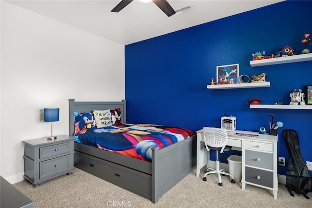 bedroom featuring baseboards, a ceiling fan, visible vents, and carpet