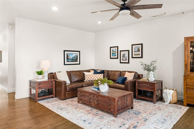 living room featuring visible vents, baseboards, wood finished floors, recessed lighting, and a ceiling fan