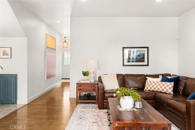 living area featuring recessed lighting, baseboards, and wood finished floors