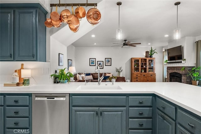 kitchen featuring a sink, open floor plan, ceiling fan, and dishwasher