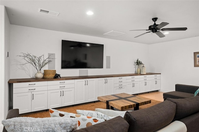 living area with visible vents, recessed lighting, ceiling fan, and light wood-type flooring