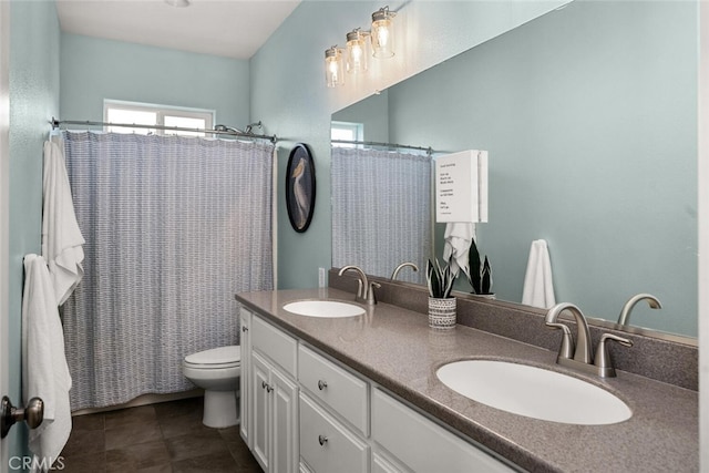 full bathroom featuring double vanity, toilet, tile patterned flooring, and a sink