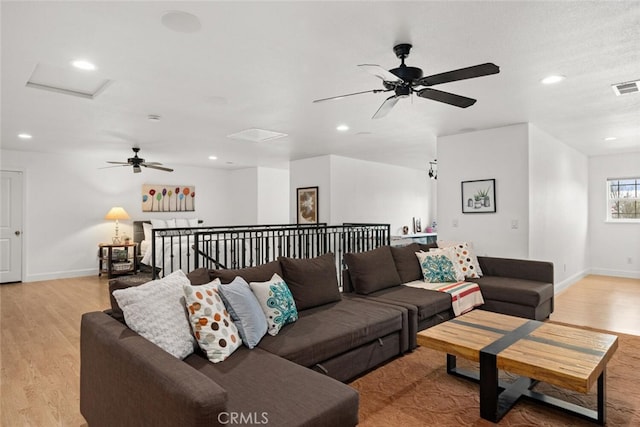 living room featuring light wood-type flooring, recessed lighting, and a ceiling fan