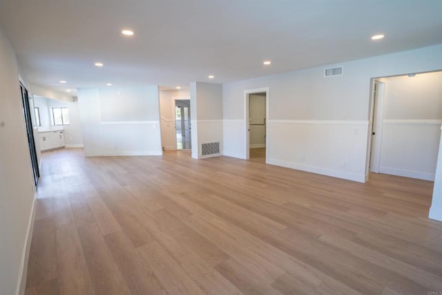 interior space with light wood finished floors, visible vents, and recessed lighting