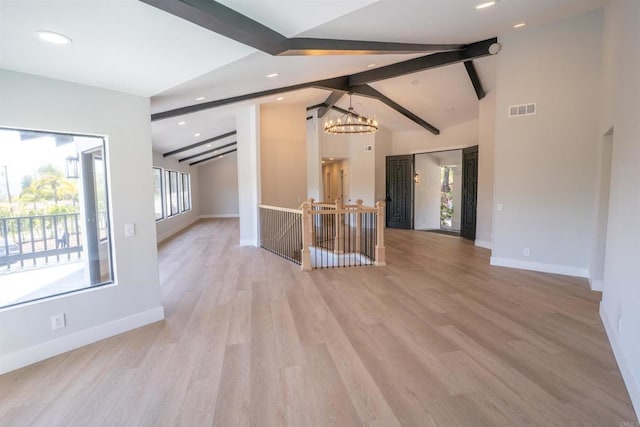 unfurnished room with vaulted ceiling with beams, baseboards, and a notable chandelier