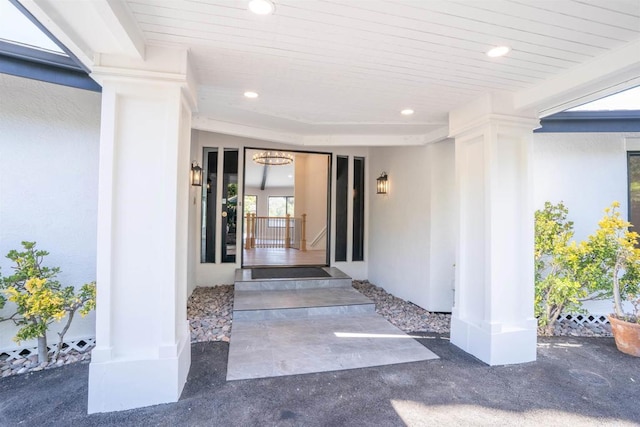 doorway to property featuring stucco siding