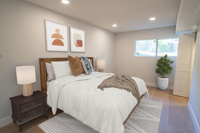 bedroom with baseboards, wood finished floors, and recessed lighting