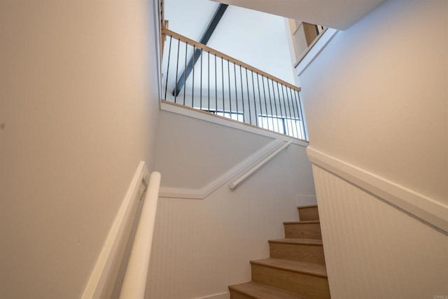 stairs featuring a towering ceiling