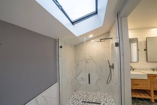 full bathroom with recessed lighting, a skylight, vanity, and a marble finish shower