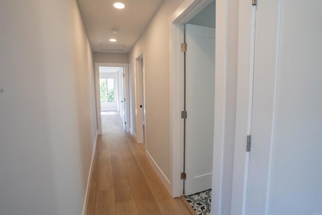 corridor with recessed lighting, light wood-style flooring, and baseboards
