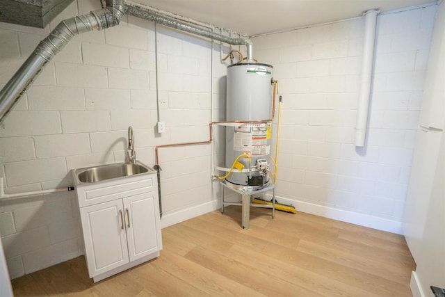 utility room with a sink and gas water heater