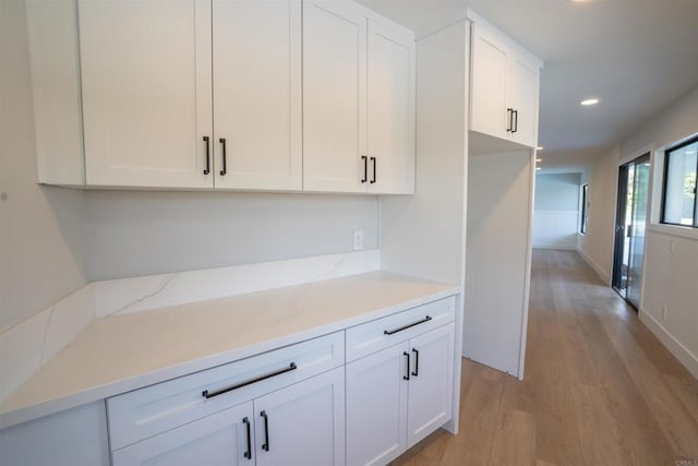 kitchen featuring white cabinets, light wood-style floors, and recessed lighting