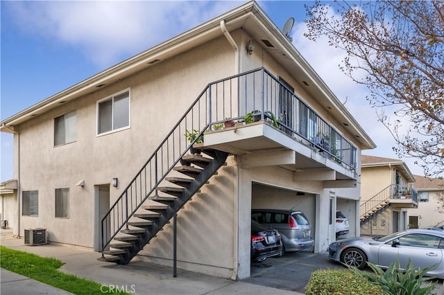 18131 Camino Bello Unit 4, Rowland Heights, CA 91748 - view of home's exterior with stairway, stucco siding, a garage, and driveway