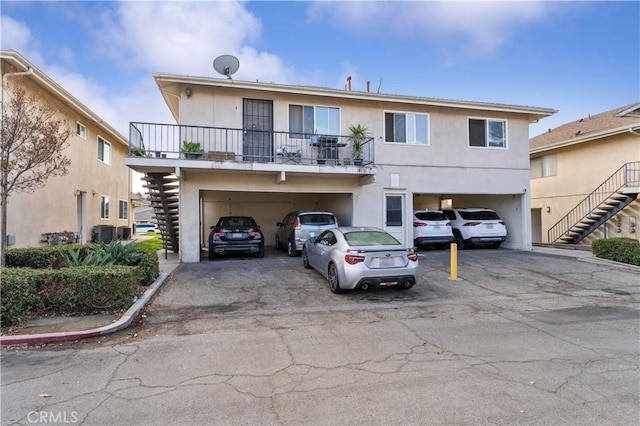 18131 Camino Bello Unit 4, Rowland Heights, CA 91748 - view of front facade featuring stairs, stucco siding, and a balcony