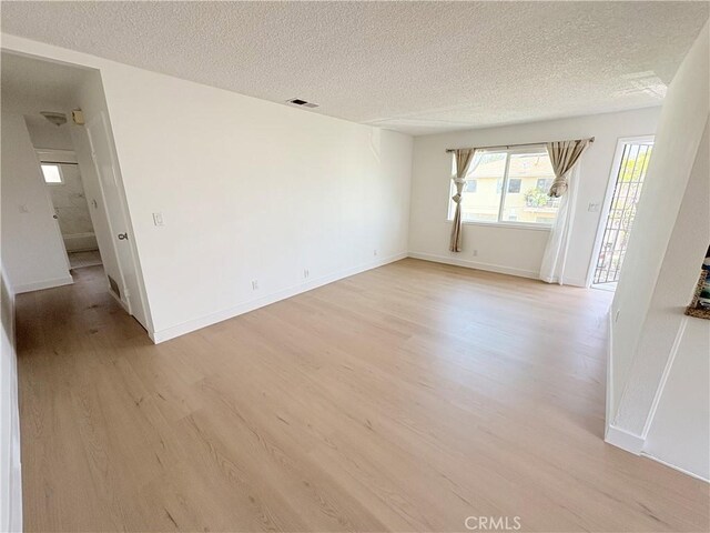 18131 Camino Bello Unit 4, Rowland Heights, CA 91748 - spare room with light wood finished floors and a textured ceiling