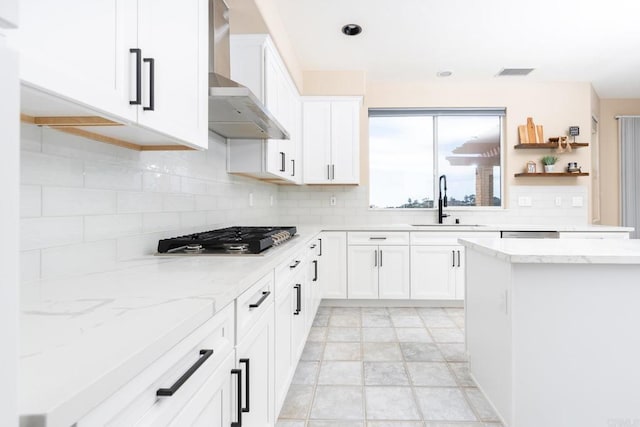 15881 Broad Oaks Rd, El Cajon, CA 92021 - kitchen with stainless steel gas stovetop, a sink, wall chimney exhaust hood, tasteful backsplash, and light stone counters