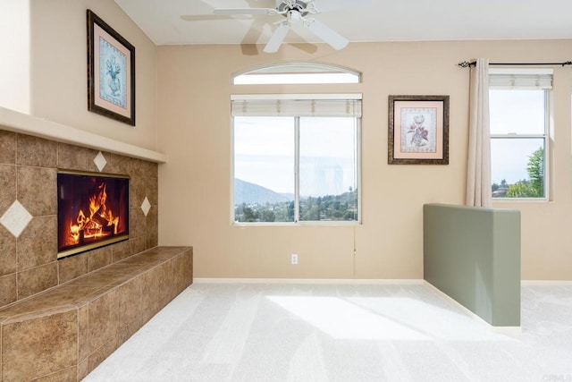 15881 Broad Oaks Rd, El Cajon, CA 92021 - unfurnished living room featuring baseboards, carpet, ceiling fan, and a tiled fireplace
