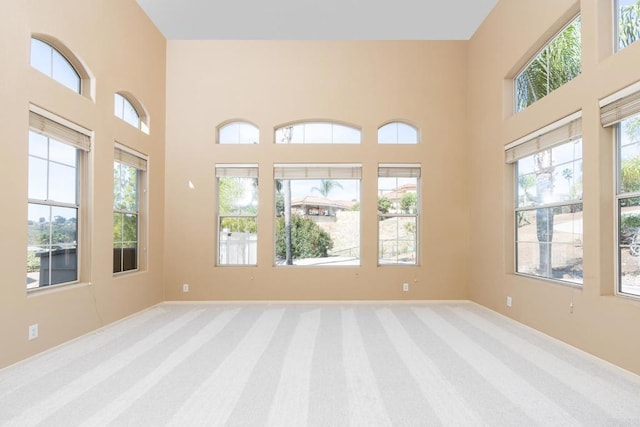 15881 Broad Oaks Rd, El Cajon, CA 92021 - unfurnished room featuring healthy amount of natural light, carpet floors, a high ceiling, and baseboards