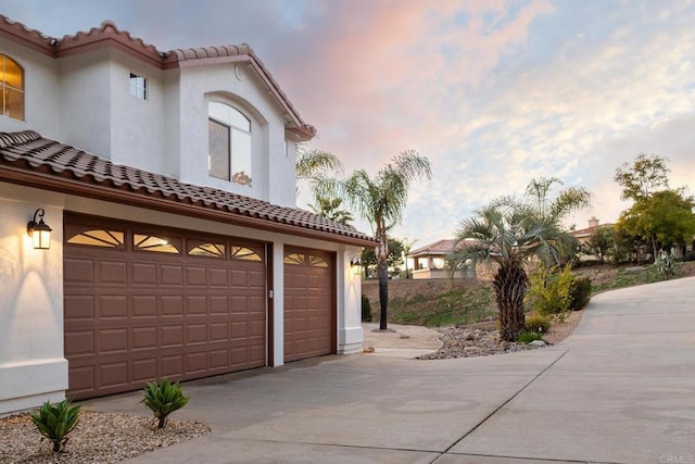15881 Broad Oaks Rd, El Cajon, CA 92021 - garage at dusk featuring concrete driveway