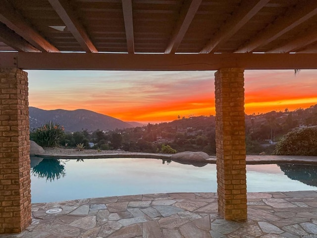 15881 Broad Oaks Rd, El Cajon, CA 92021 - pool at dusk featuring a mountain view, an outdoor pool, and a patio